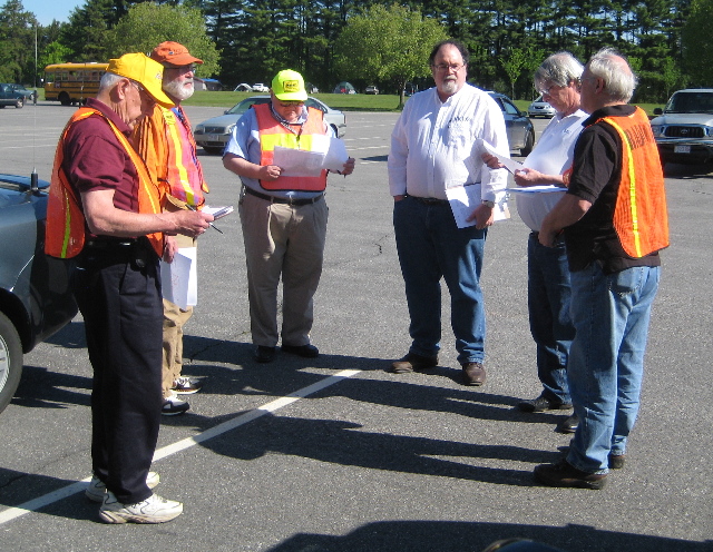 crew of 6 standing in parking lot